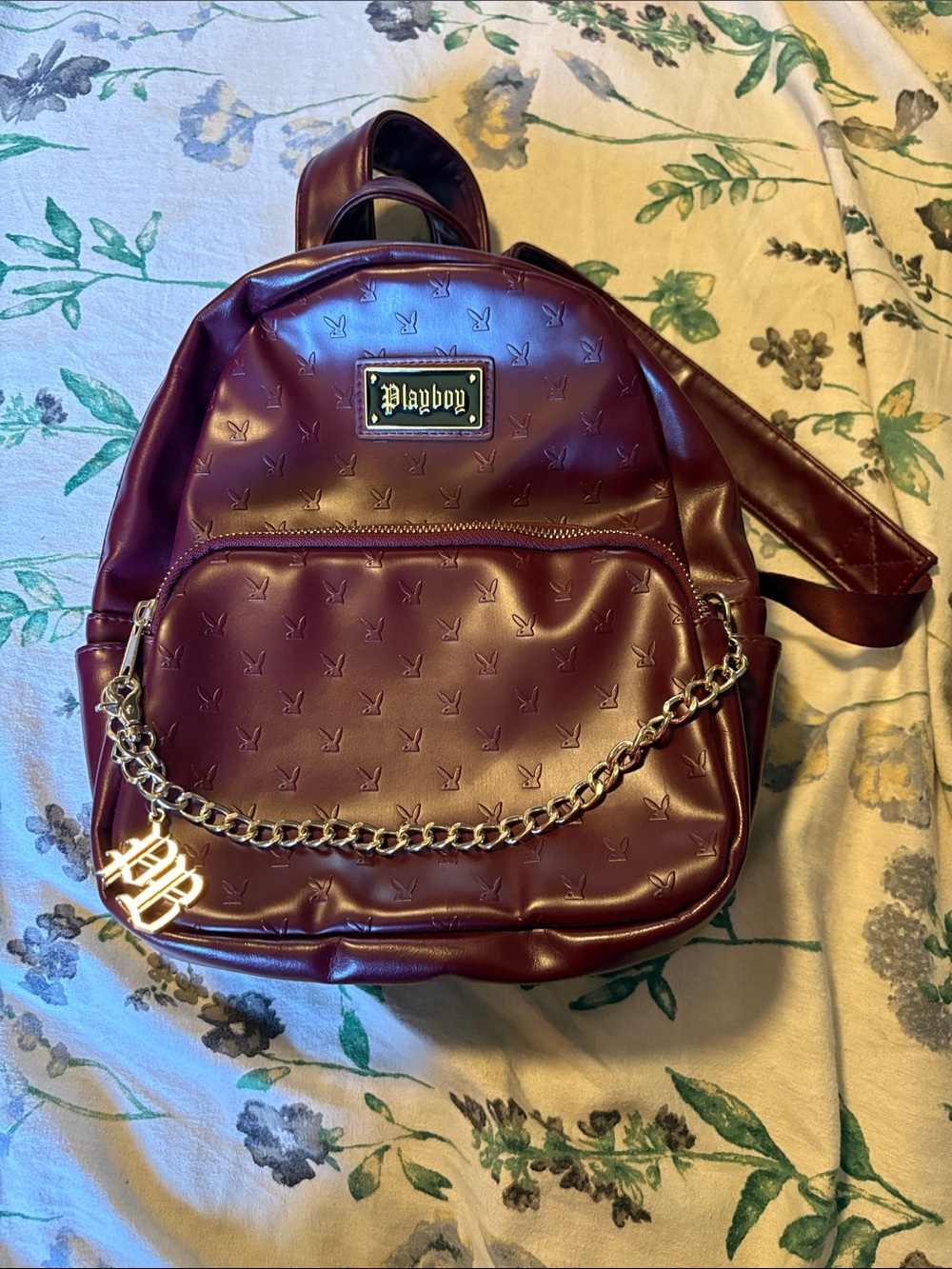PLAYBOY Burgundy Mini Backpack with Gold Chain Accent